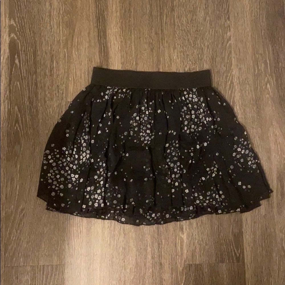 Black skirt with white flowers.